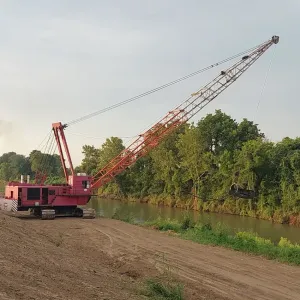 Dragline reaching across the channel at first light
