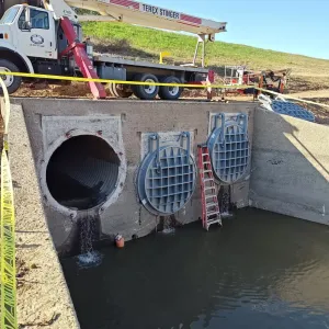 Two new gates seated and the third culvert opening prepped, seepage draining into the dewatered basin