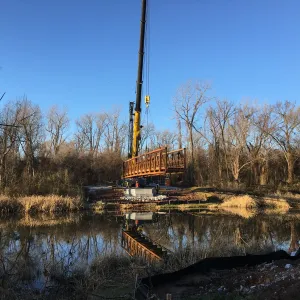 The first prefabricated bridge section lifted into position above Horton Slough