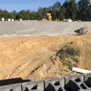 A completed run of MSE wall with mass grading underway above it