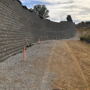 The finished wall face and gravel drainage strip along its base